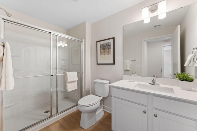 7478 170th Ave NW, Ramsey, MN 55303 - full bathroom with wood finished floors, toilet, a stall shower, vanity, and baseboards