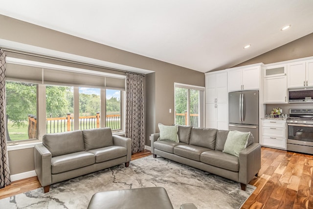 1270 145th Ave NW, Andover, MN 55304 - living room featuring vaulted ceiling, light wood finished floors, recessed lighting, and baseboards