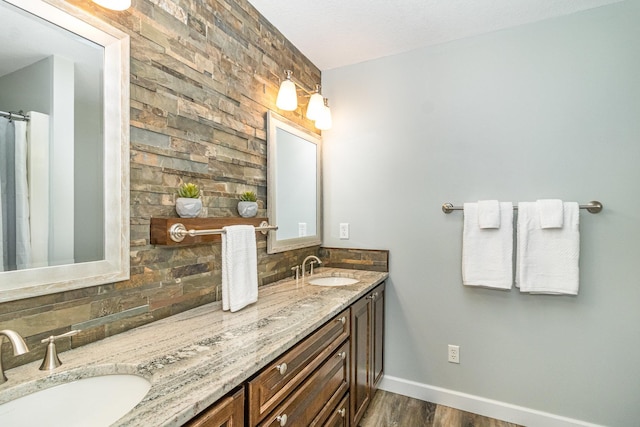 1270 145th Ave NW, Andover, MN 55304 - full bathroom featuring backsplash, double vanity, wood finished floors, and baseboards