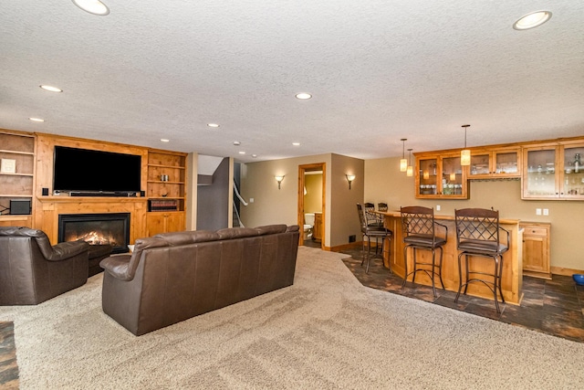 1270 145th Ave NW, Andover, MN 55304 - living room featuring baseboards, recessed lighting, a glass covered fireplace, bar, and a textured ceiling
