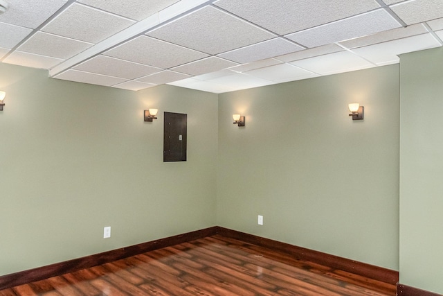 1270 145th Ave NW, Andover, MN 55304 - unfurnished room with electric panel, a paneled ceiling, dark wood-type flooring, and baseboards