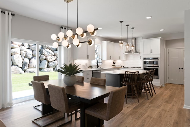 19554 105th Ave, Corcoran, MN 55374 - dining room with light wood-type flooring, recessed lighting, and a chandelier