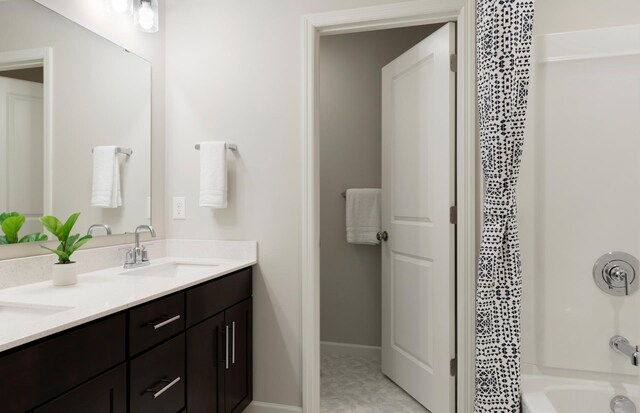 19600 104th Pl, Corcoran, MN 55374 - full bathroom with double vanity, shower / tub combination, and baseboards