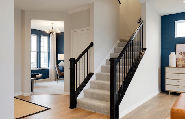 19600 104th Pl, Corcoran, MN 55374 - stairs with wood finished floors, a chandelier, and baseboards