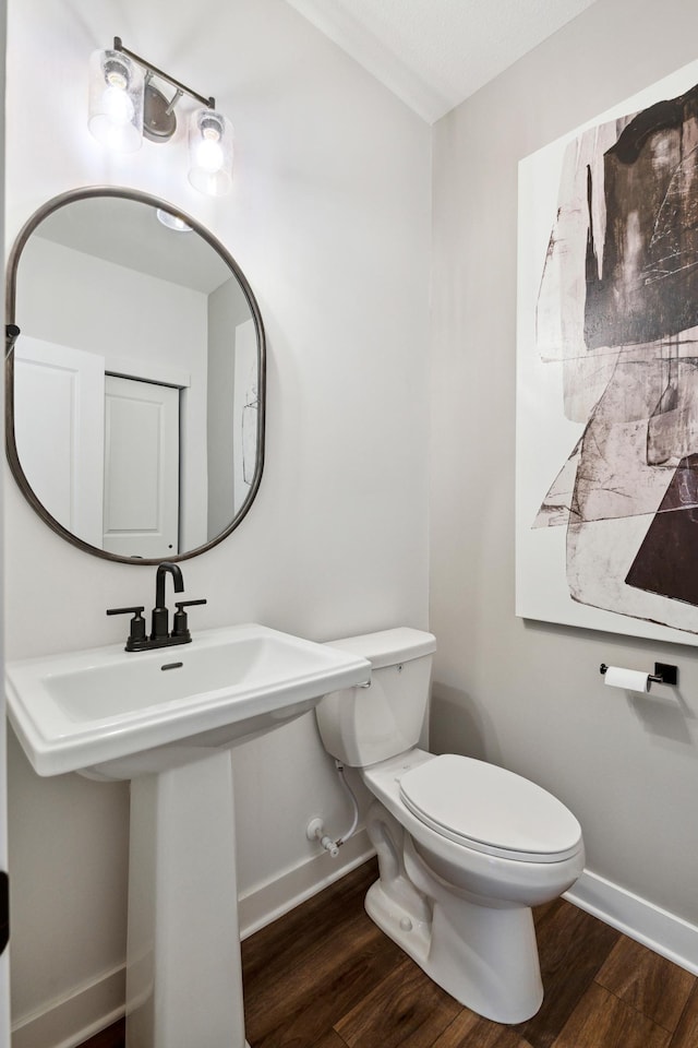 19649 105th Ave, Corcoran, MN 55374 - half bathroom featuring wood finished floors, baseboards, and toilet