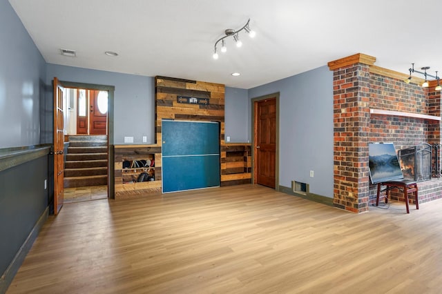 8132 Fillmore St NE, Spring Lake Park, MN 55432 - living room featuring a brick fireplace, wood finished floors, stairs, and baseboards