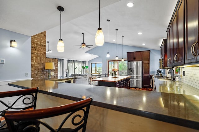8132 Fillmore St NE, Spring Lake Park, MN 55432 - kitchen with stainless steel fridge with ice dispenser, ceiling fan, backsplash, vaulted ceiling, and a center island