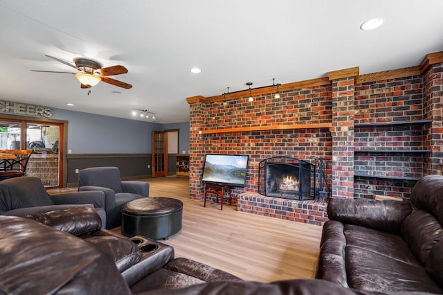 8132 Fillmore St NE, Spring Lake Park, MN 55432 - living area featuring a fireplace, wood finished floors, a ceiling fan, and recessed lighting