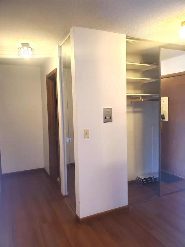 8935 Old Cedar Ave S Unit 113, Bloomington, MN 55425 - corridor featuring wood finished floors, a textured ceiling, and baseboards