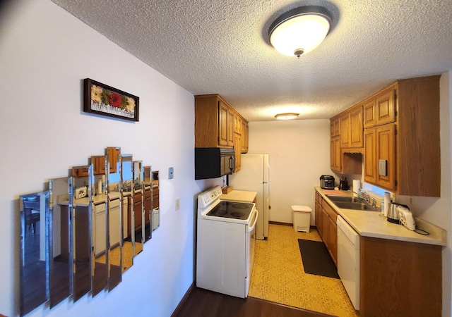 8935 Old Cedar Ave S Unit 113, Bloomington, MN 55425 - kitchen featuring white appliances, a sink, light countertops, a textured ceiling, and dark wood-style floors