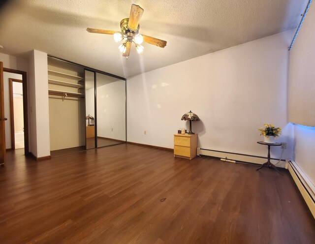 8935 Old Cedar Ave S Unit 113, Bloomington, MN 55425 - unfurnished bedroom featuring wood finished floors, a textured ceiling, a baseboard heating unit, a ceiling fan, and baseboards