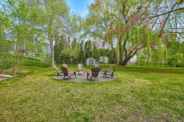 2167 Woodbridge Way, Woodbury, MN 55125 - view of green lawn with a fire pit, a shed, and an outdoor structure