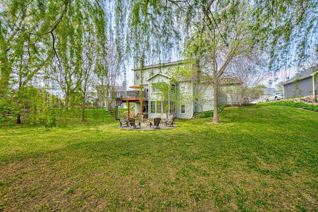 2167 Woodbridge Way, Woodbury, MN 55125 - view of grassy yard with an outdoor fire pit, a wooden deck, and a patio area
