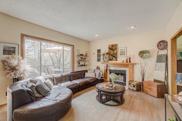 2167 Woodbridge Way, Woodbury, MN 55125 - living room with a fireplace, wood finished floors, a textured ceiling, and recessed lighting
