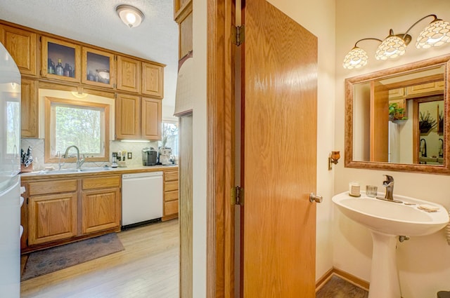 2167 Woodbridge Way, Woodbury, MN 55125 - bathroom with wood finished floors, a sink, and decorative backsplash