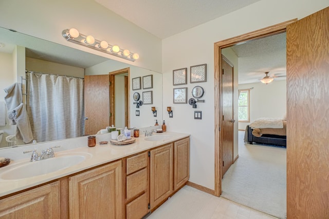 2167 Woodbridge Way, Woodbury, MN 55125 - full bath with double vanity, ensuite bath, baseboards, and ceiling fan