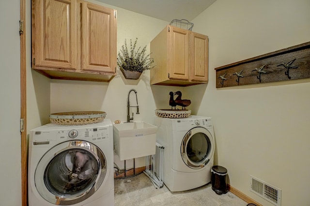 2167 Woodbridge Way, Woodbury, MN 55125 - laundry area with cabinet space, washing machine and clothes dryer, and baseboards