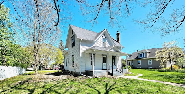 view of front of home featuring a porch and a chimney