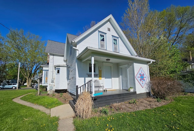 view of front of house featuring covered porch and a front lawn