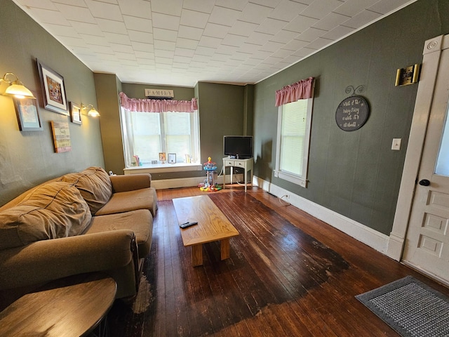 living area featuring hardwood / wood-style flooring and baseboards