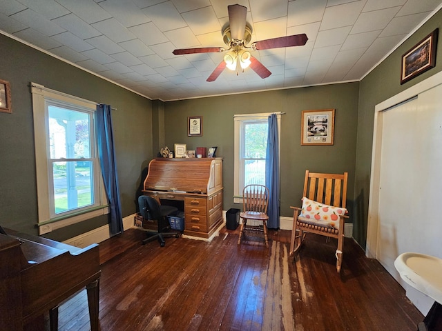 office space featuring hardwood / wood-style floors, crown molding, and a ceiling fan