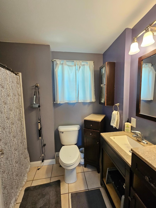 full bath featuring tile patterned flooring, vanity, and toilet