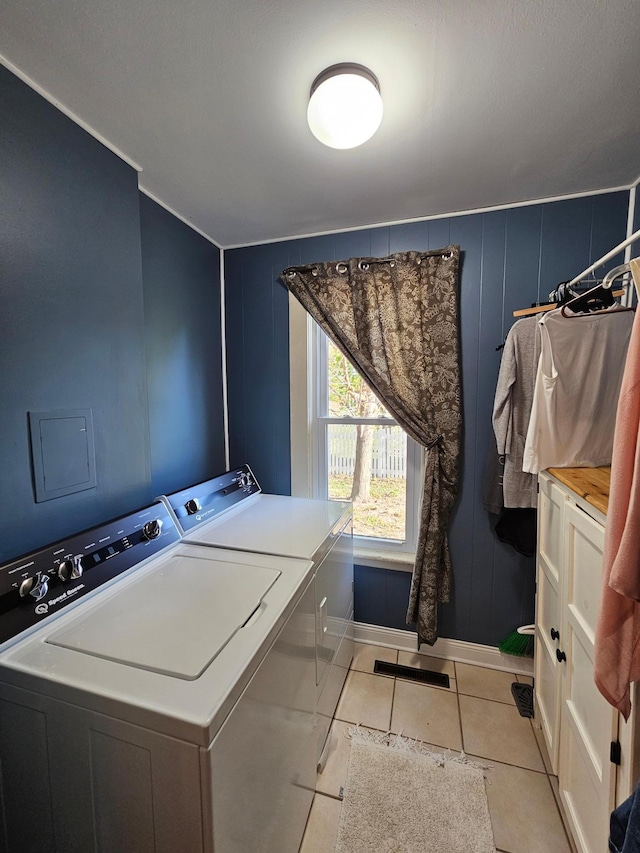 laundry room featuring washer and dryer, baseboards, and light tile patterned floors