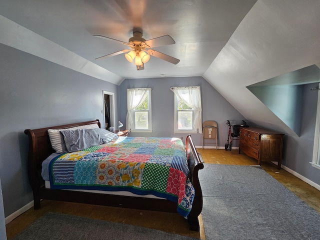 bedroom featuring vaulted ceiling, baseboards, and ceiling fan