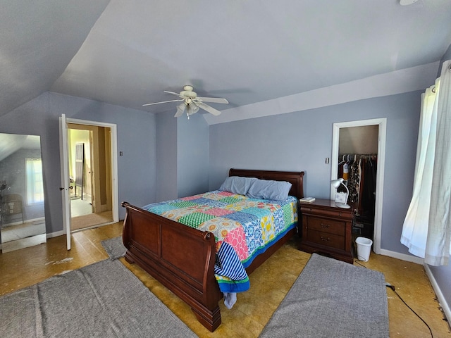 bedroom featuring a ceiling fan, lofted ceiling, and baseboards