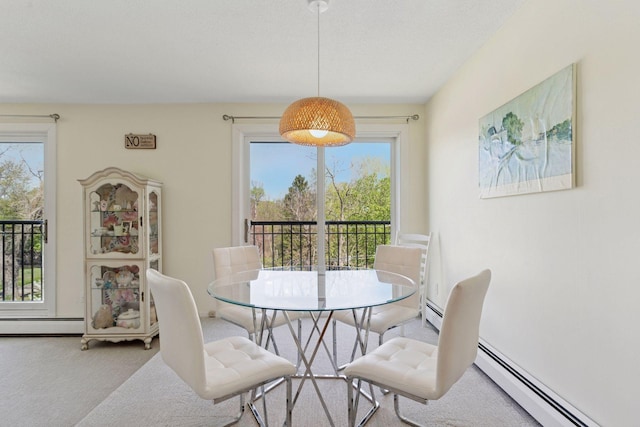 carpeted dining area featuring healthy amount of natural light and a baseboard radiator
