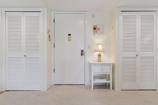 entrance foyer featuring carpet flooring and baseboards