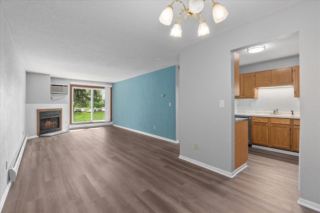 3440 Golfview Dr Unit 123, Eagan, MN 55123 - unfurnished living room with a baseboard radiator, a chandelier, a textured ceiling, wood finished floors, and a warm lit fireplace