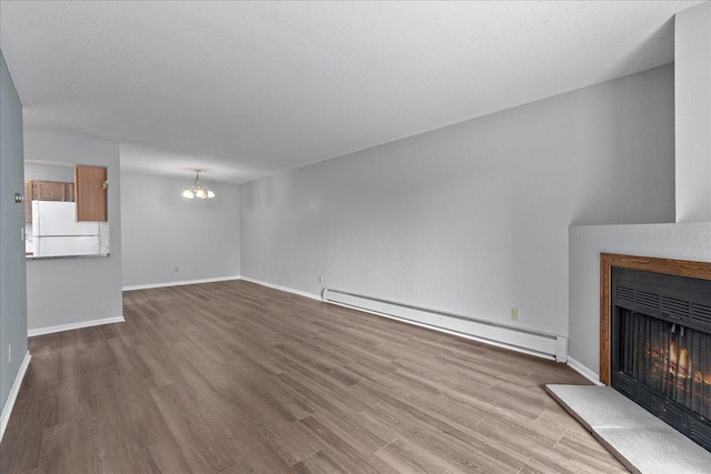 3440 Golfview Dr Unit 123, Eagan, MN 55123 - unfurnished living room with a baseboard radiator, a lit fireplace, a chandelier, wood finished floors, and baseboards