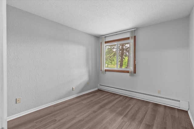 3440 Golfview Dr Unit 123, Eagan, MN 55123 - empty room with baseboard heating, wood finished floors, a textured ceiling, and baseboards