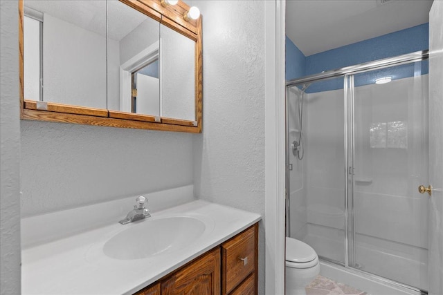 3440 Golfview Dr Unit 123, Eagan, MN 55123 - full bathroom featuring toilet, a shower stall, vanity, and a textured wall