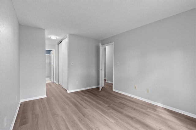 3440 Golfview Dr Unit 123, Eagan, MN 55123 - unfurnished room with light wood-type flooring, baseboards, and a textured ceiling