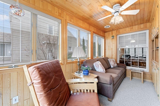 sunroom featuring wooden walls, wood ceiling, and carpet flooring