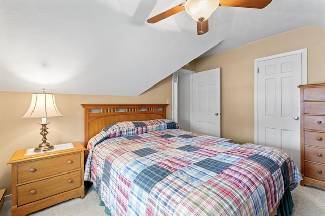 bedroom featuring light carpet, lofted ceiling, and ceiling fan
