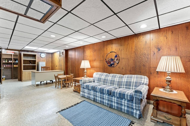 living room featuring recessed lighting and wood walls