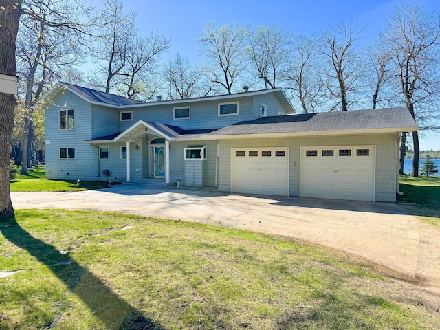 49262 Big Pine Rd, Perham, MN 56573 - view of front facade featuring driveway, an attached garage, a front lawn, and a shingled roof