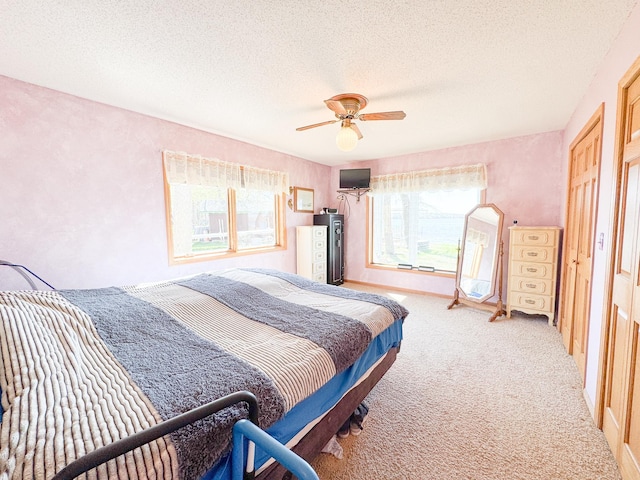 49262 Big Pine Rd, Perham, MN 56573 - bedroom featuring light colored carpet, water heater, a textured ceiling, and a ceiling fan