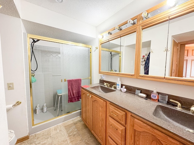 49262 Big Pine Rd, Perham, MN 56573 - full bathroom featuring a shower stall, a textured ceiling, double vanity, and tile patterned floors