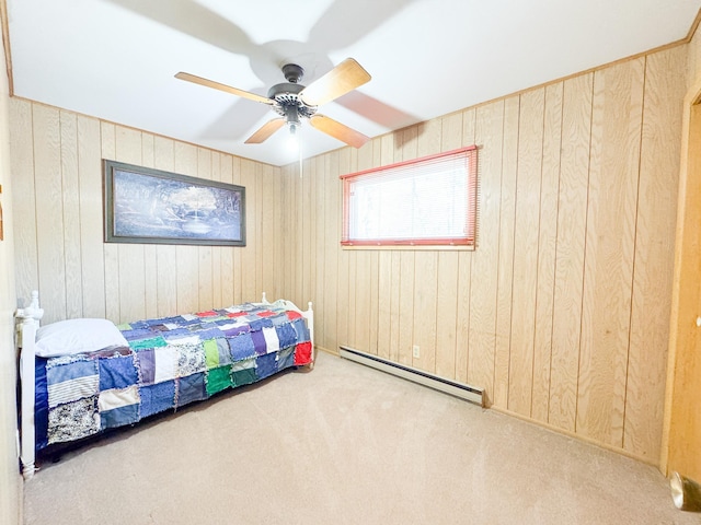 49262 Big Pine Rd, Perham, MN 56573 - carpeted bedroom with a baseboard radiator, wood walls, and ceiling fan