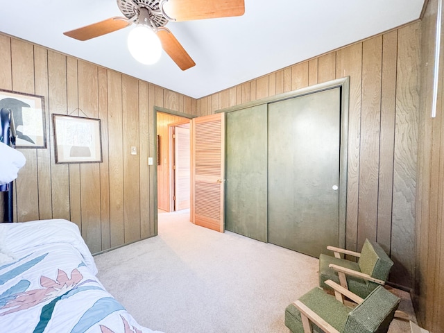 49262 Big Pine Rd, Perham, MN 56573 - carpeted bedroom with wood walls, ceiling fan, and a closet