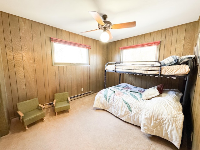 49262 Big Pine Rd, Perham, MN 56573 - carpeted bedroom featuring a baseboard radiator, multiple windows, a baseboard heating unit, wooden walls, and a ceiling fan