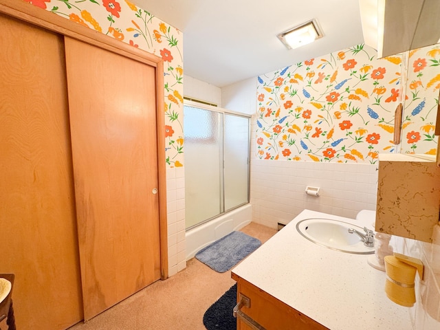 49262 Big Pine Rd, Perham, MN 56573 - bathroom featuring wallpapered walls, a shower with door, vanity, wainscoting, and tile walls