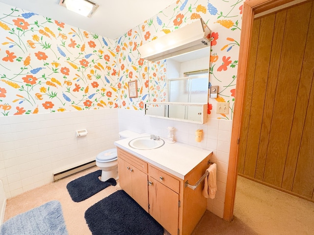 49262 Big Pine Rd, Perham, MN 56573 - full bath featuring wallpapered walls, a baseboard heating unit, wainscoting, tile walls, and vanity