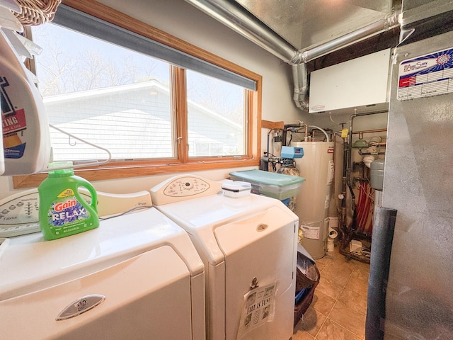 49262 Big Pine Rd, Perham, MN 56573 - clothes washing area featuring washing machine and clothes dryer, water heater, and tile patterned flooring