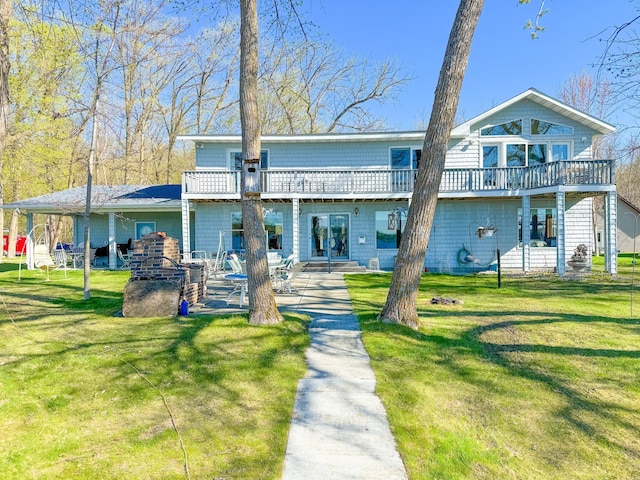 49262 Big Pine Rd, Perham, MN 56573 - rear view of house featuring a lawn, a deck, and a patio