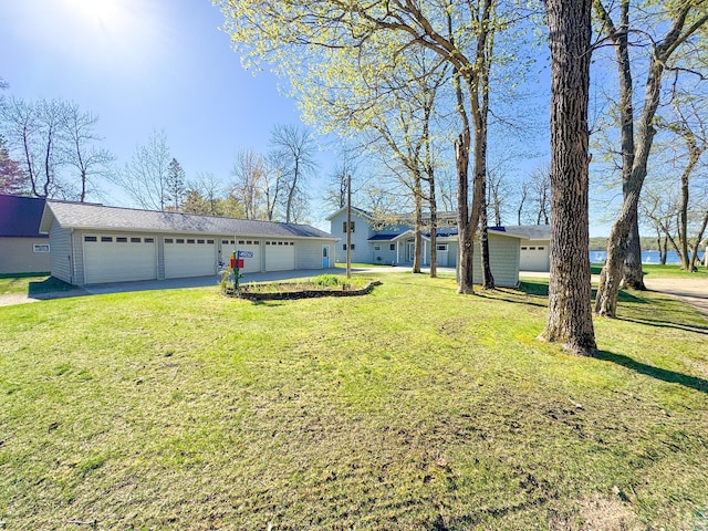 49262 Big Pine Rd, Perham, MN 56573 - view of grassy yard featuring asphalt driveway and a garage